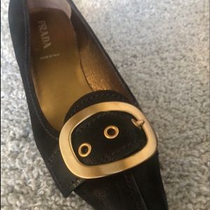 PRADA black shoes with 1 1/2” gold heel and gold buckle. NEW.